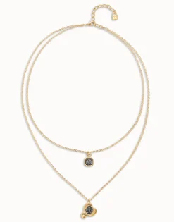 Colgante bañado en oro 18k con doble cadena y corazones con cristal negro